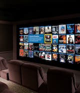 Home theatre room, showing various on demand movie options on the screen.