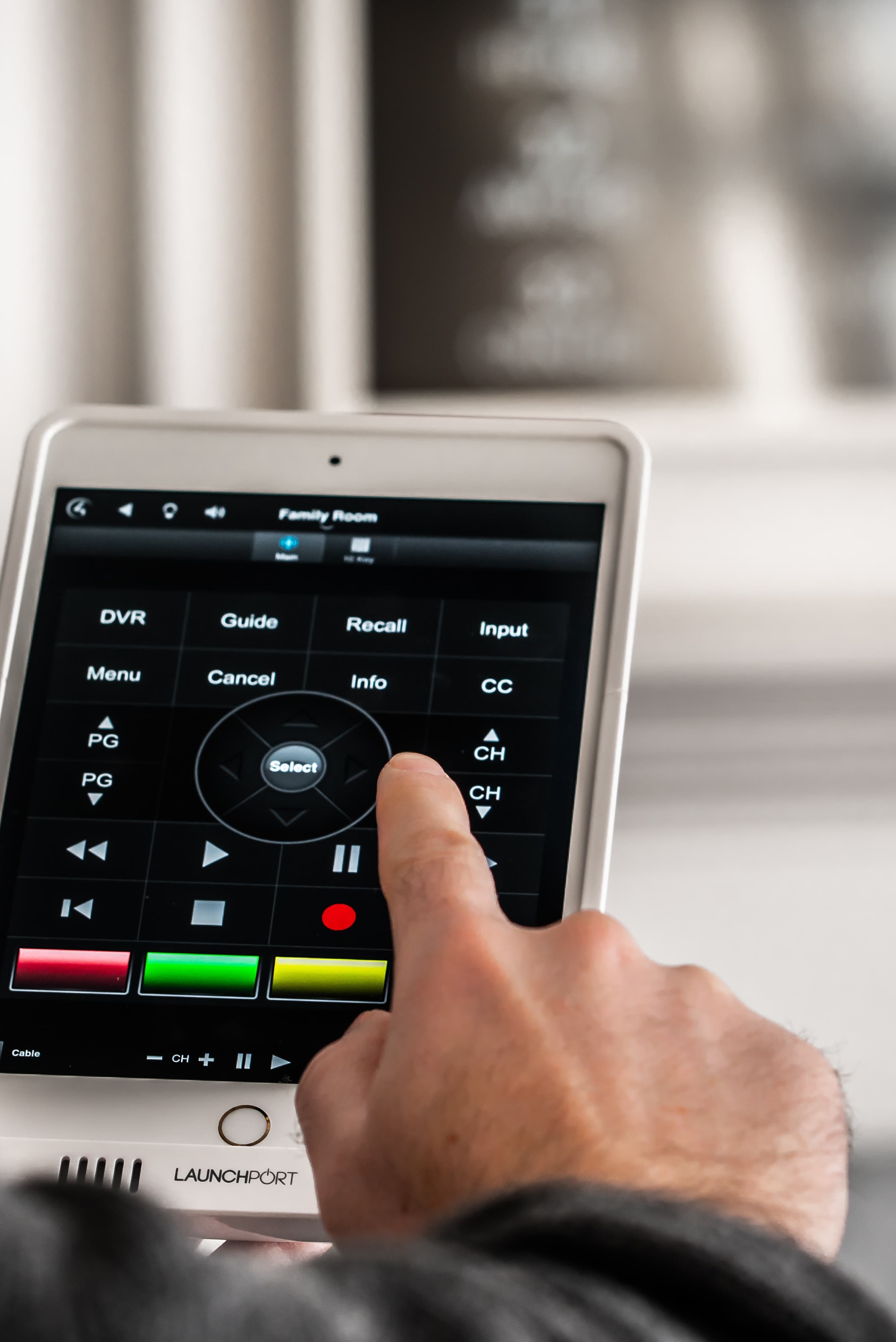 This image shows someone using an app on their ipad to control their home theatre system.