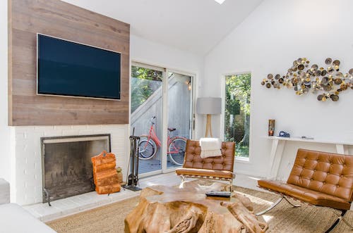 Living room with a TV mounted on the wall.